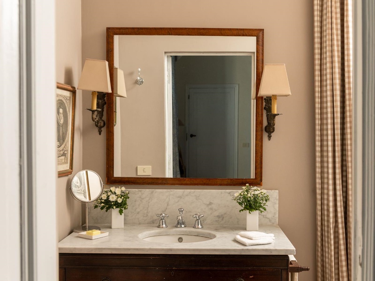Bathroom with marble wash basin and mirror at Villa delle Vigne in Tuscany