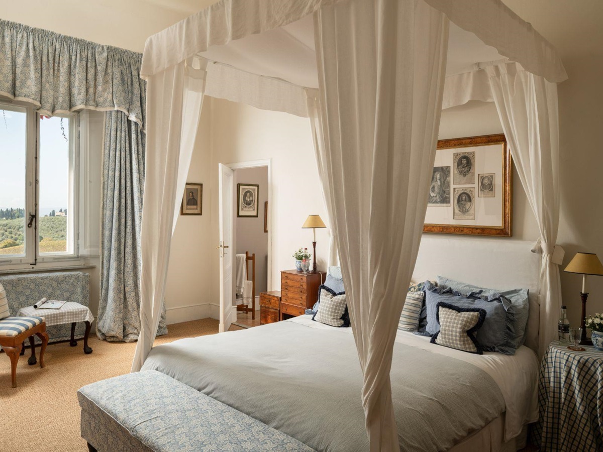 Large bedroom with double bed and large window at Villa delle Vigne in Tuscany