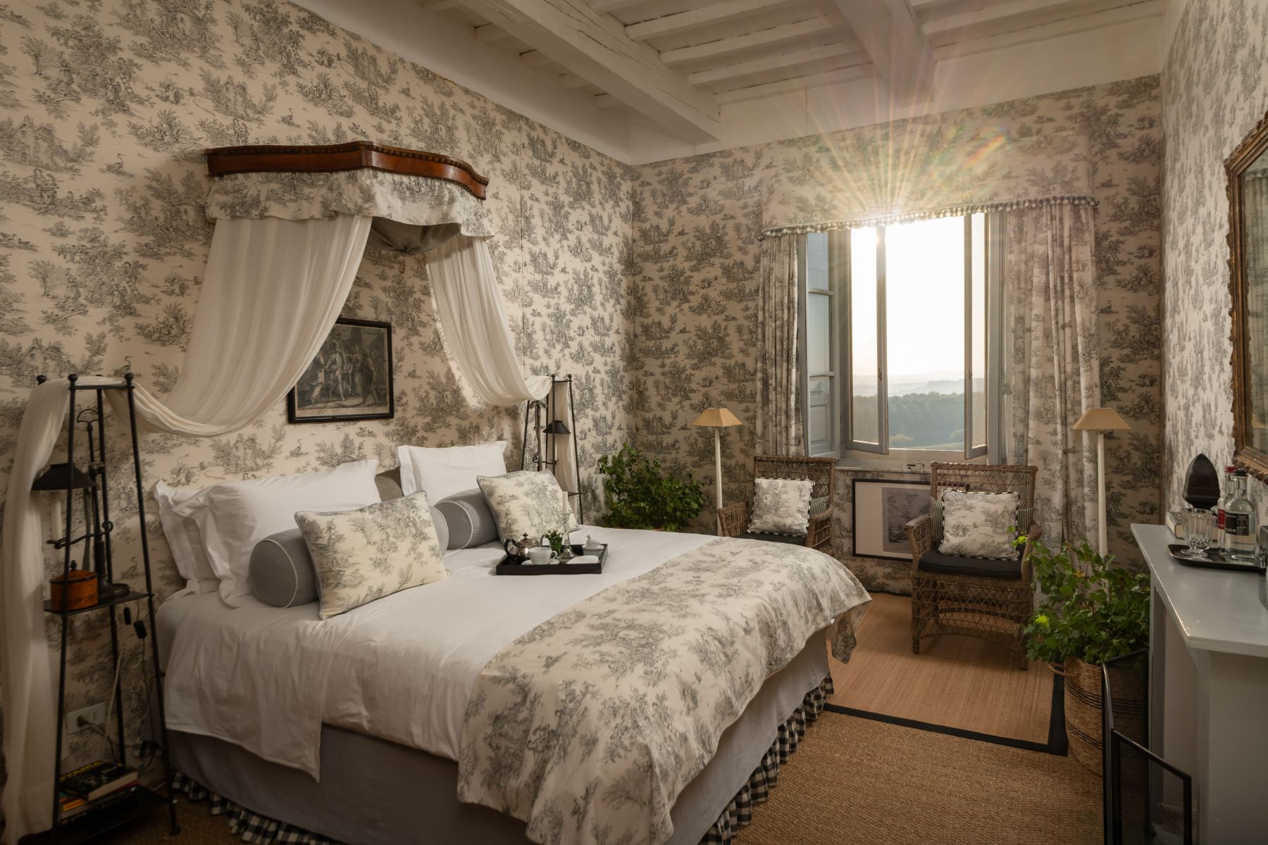 Large bedroom with double bed and armchairs at Villa delle Vigne in Tuscany