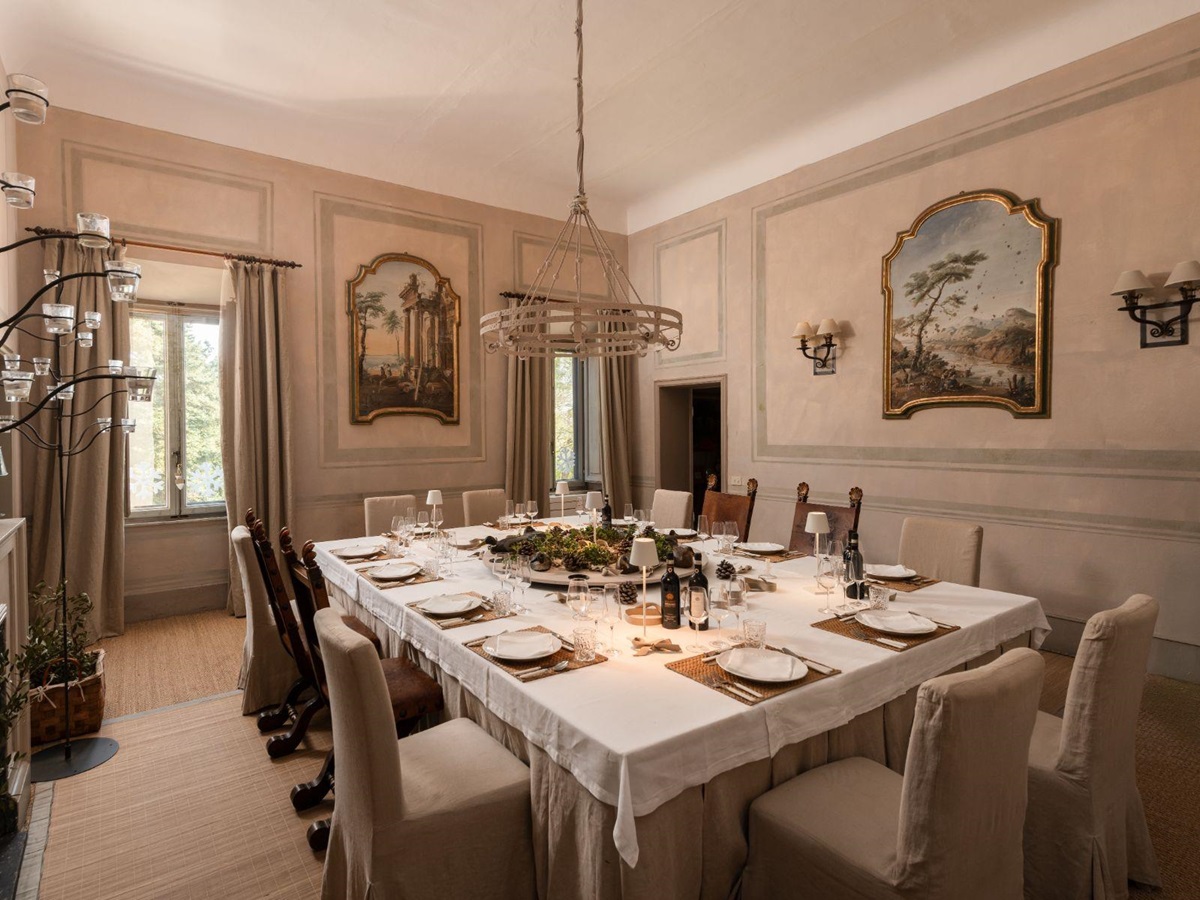 Indoor dining room with a large table in the middle at Villa delle Vigne in Tuscany