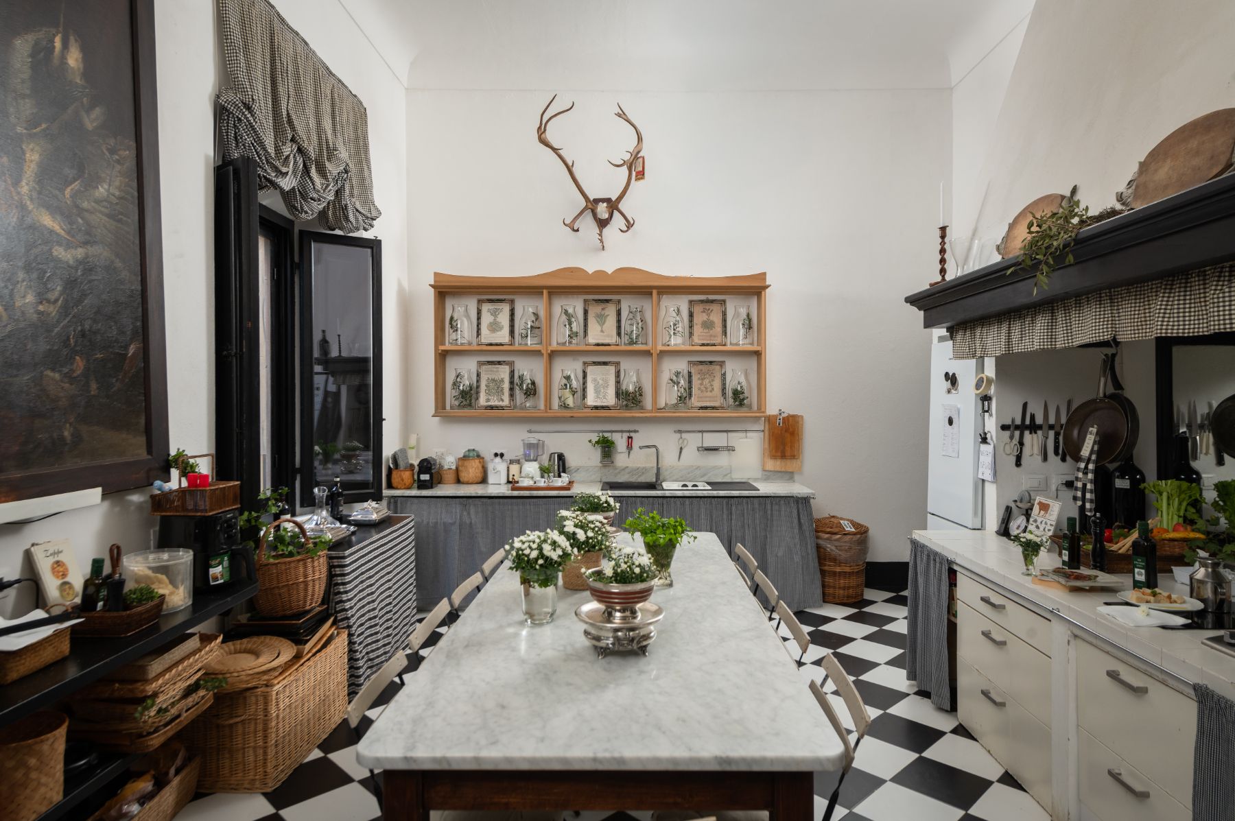 Kitchen with long marble kitchen table and work surfaces at Villa delle Vigne in Tuscany