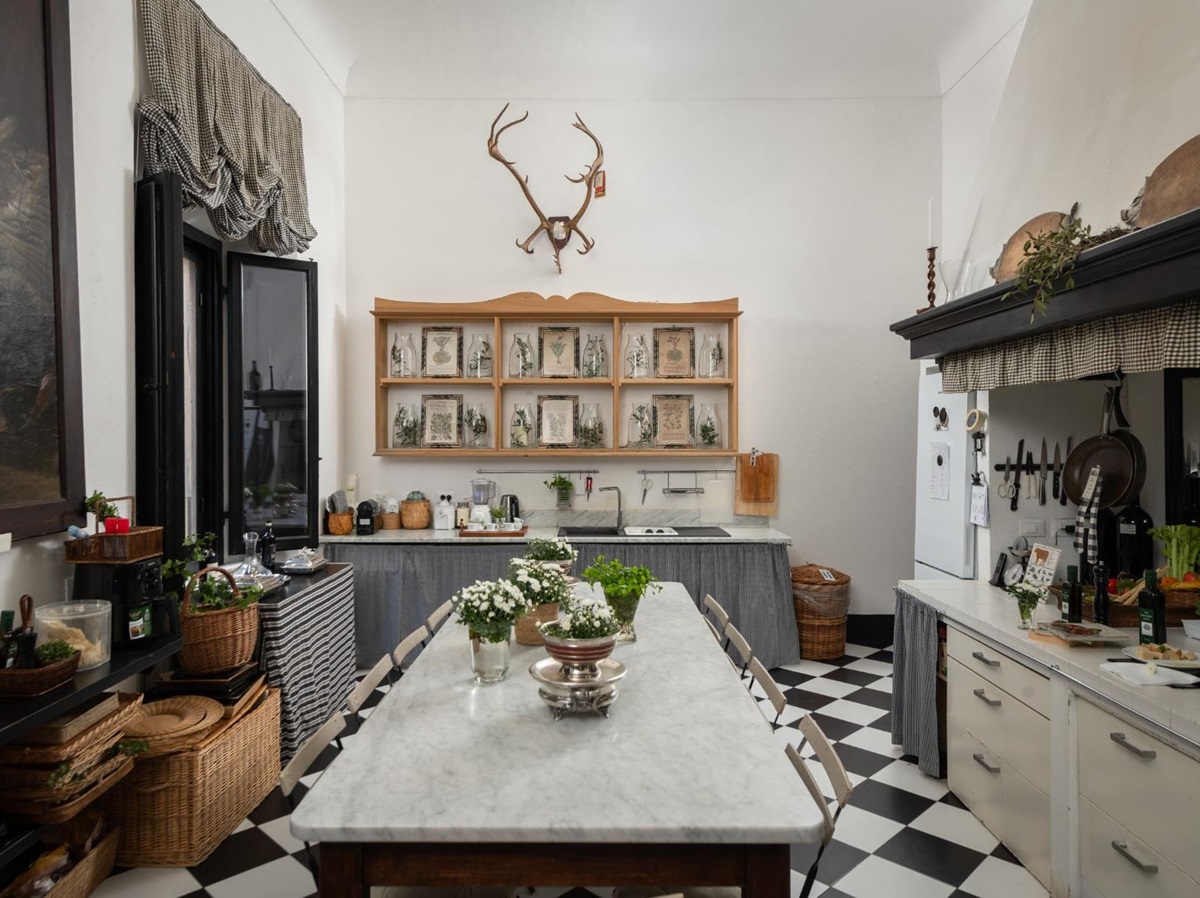 Kitchen with long marble kitchen table and work surfaces at Villa delle Vigne in Tuscany