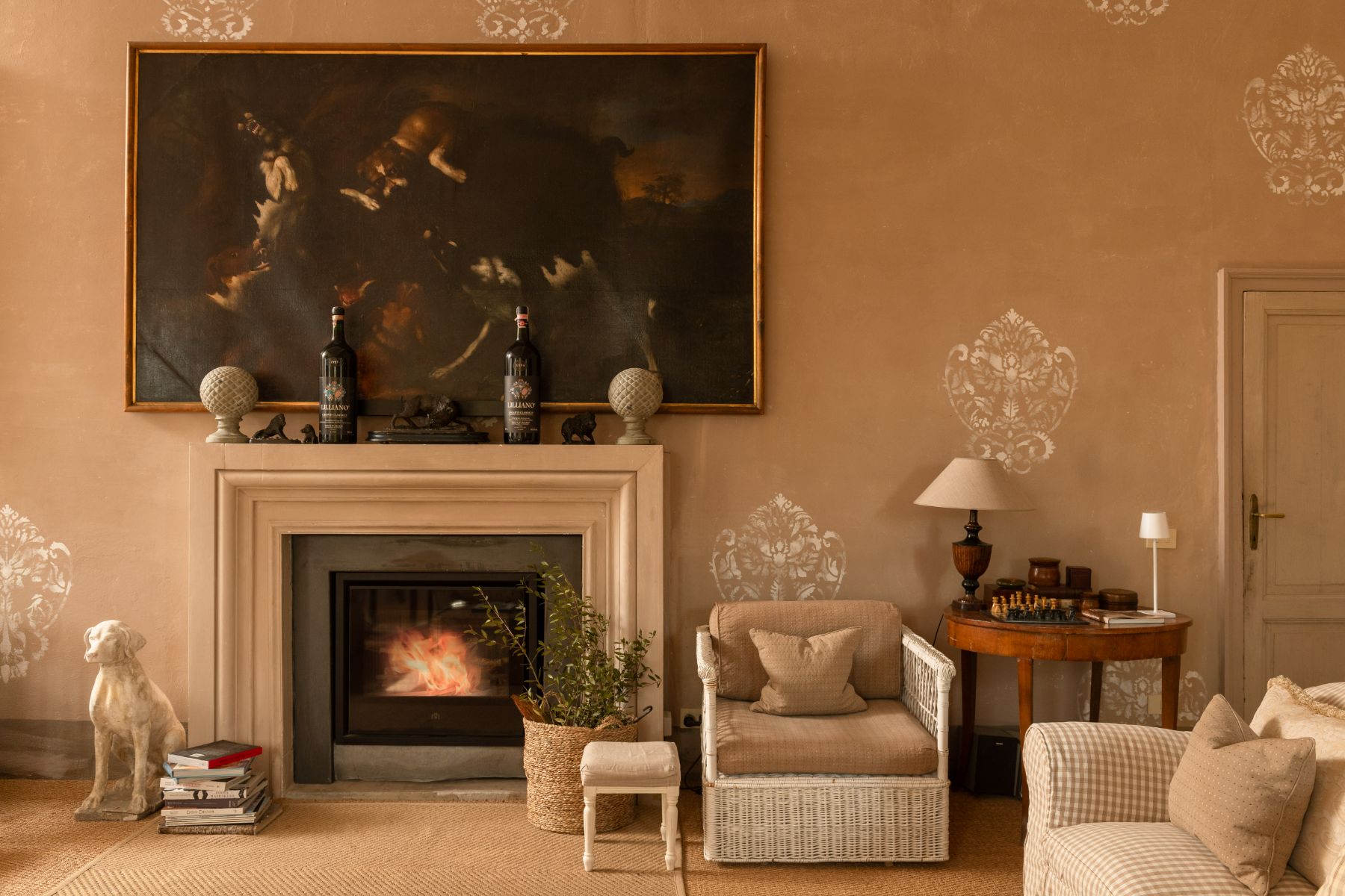Living room with armchairs and a fireplace at Villa delle Vigne in Tuscany