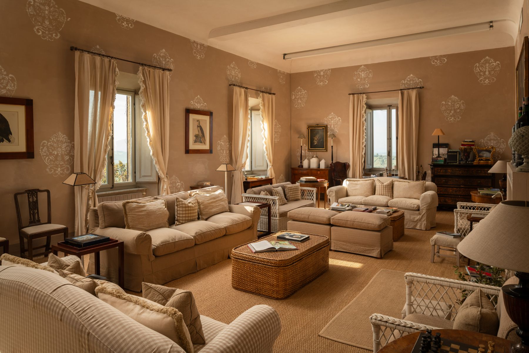 Living room with four large sofas and a wooden cabinet at Villa delle Vigne in Tuscany