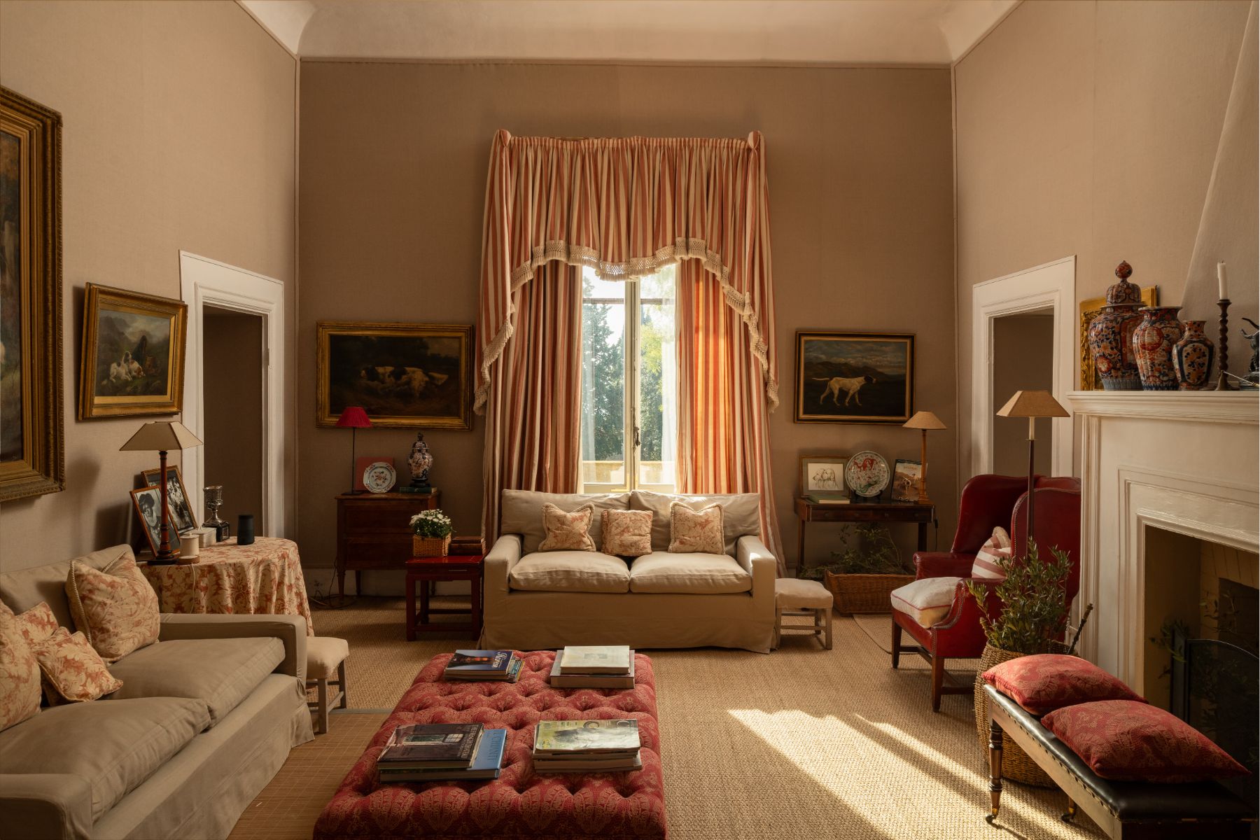 Living room with sofas and a large window with curtains at Villa delle Vigne in Tuscany