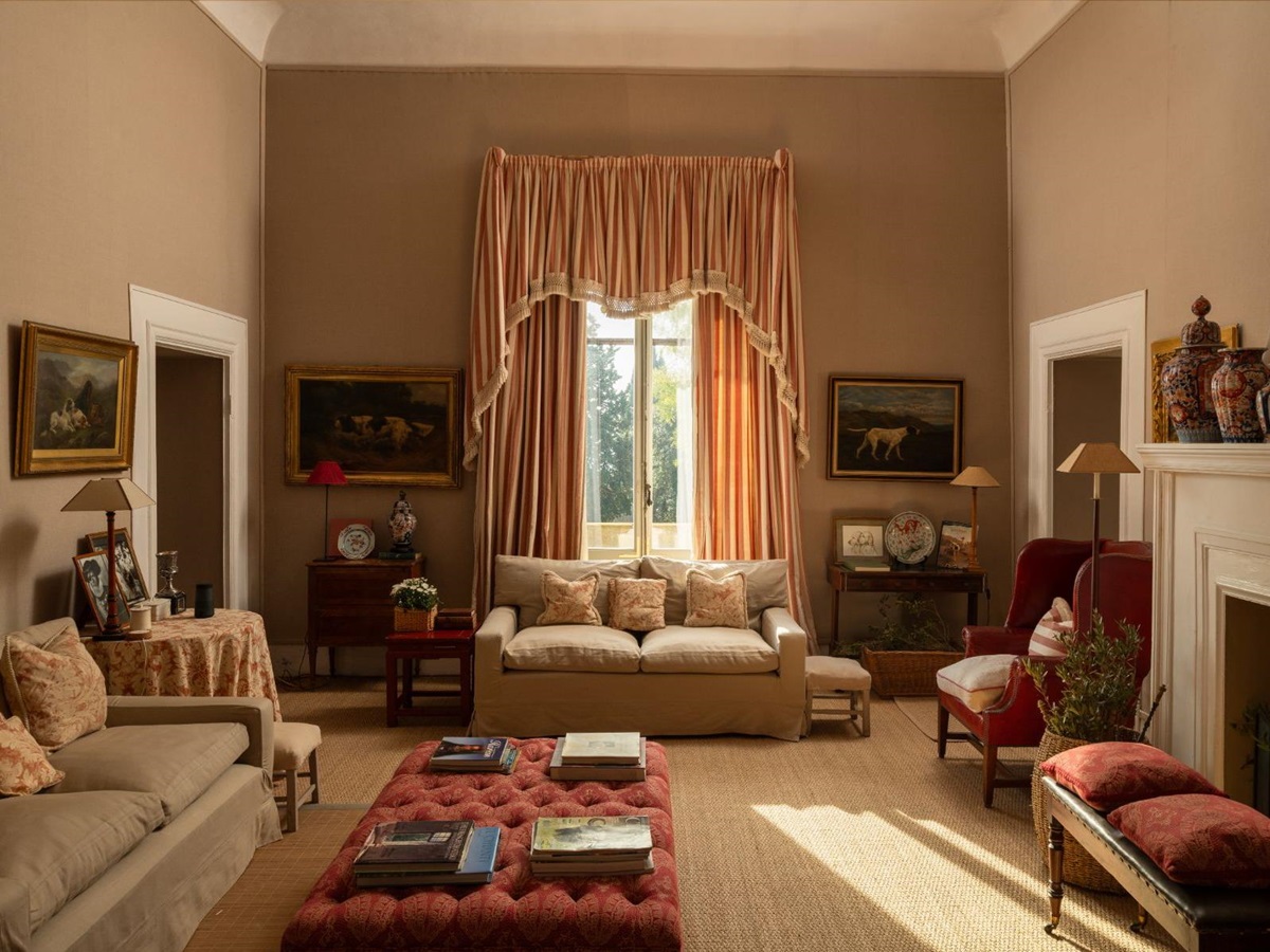 Living room with sofas and a large window with curtains at Villa delle Vigne in Tuscany