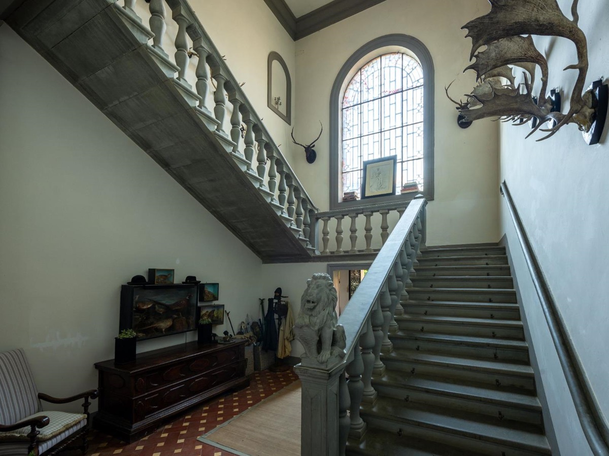 Stairs indoors at Villa delle Vigne in Tuscany with a large window