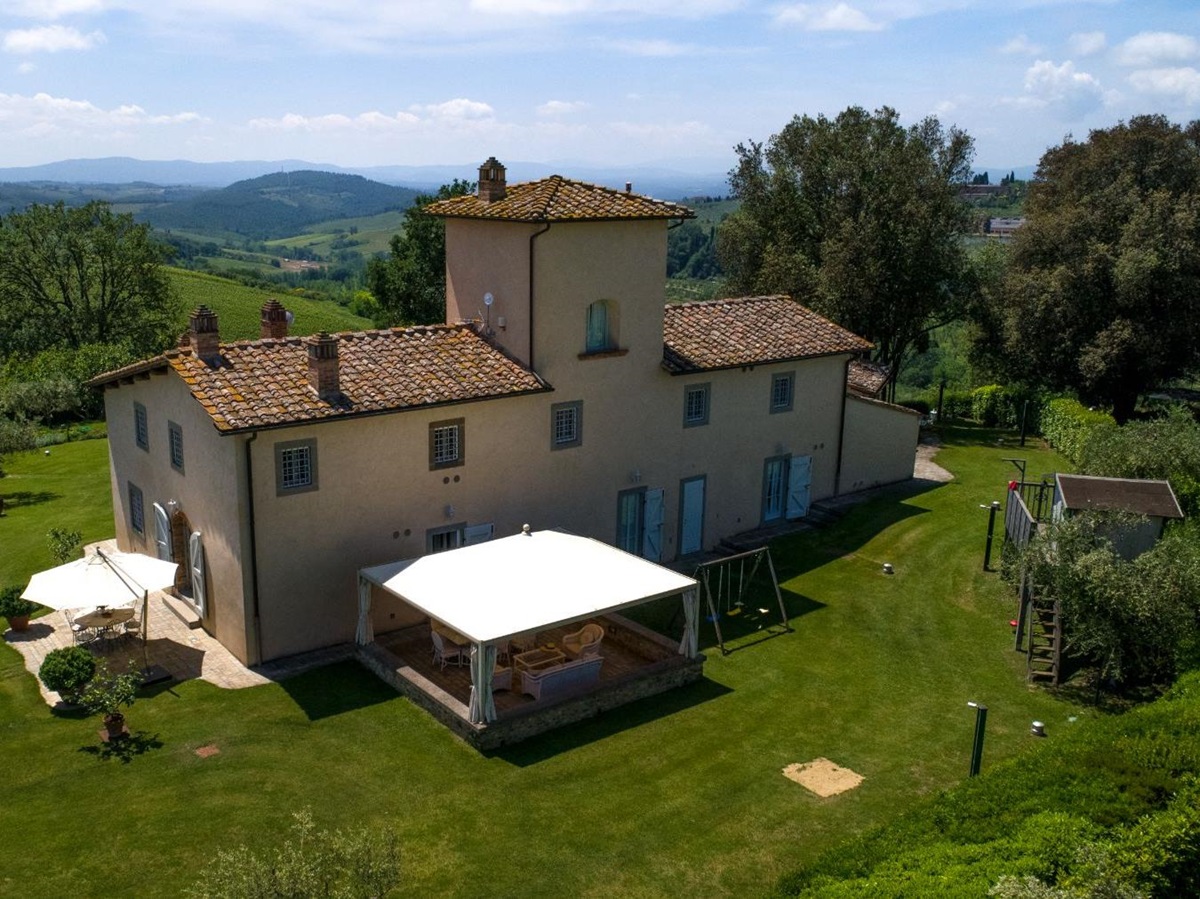 Back of Villa di Tignano in Tuscany with view of the play area and outdoor dining