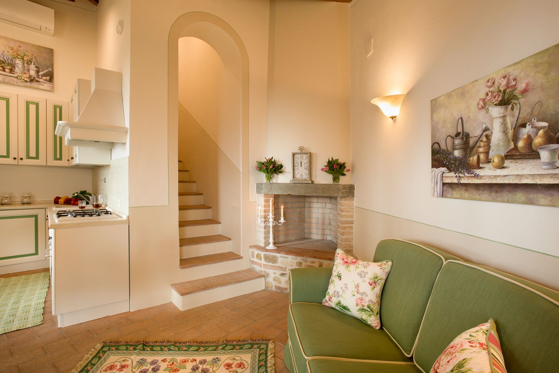 Green sofa and stairs in the ground floor of the dependance at Villa di Tignano in Tuscany