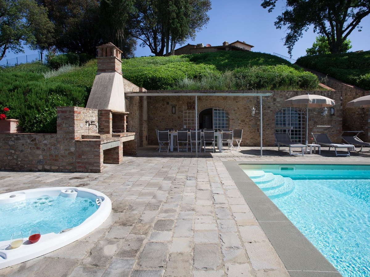 Outdoor pool area with view of the jacuzzi next to the pool at Villa di Tignano in Tuscany