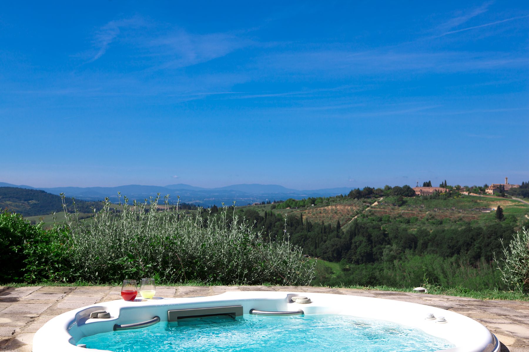 Outdoor jacuzzi overlooking the hills at Villa di Tignano in Tuscany