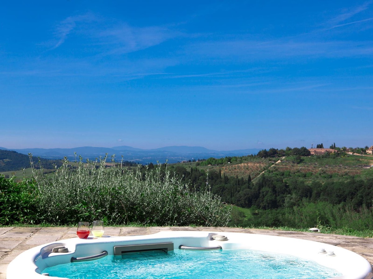 Outdoor jacuzzi overlooking the hills at Villa di Tignano in Tuscany
