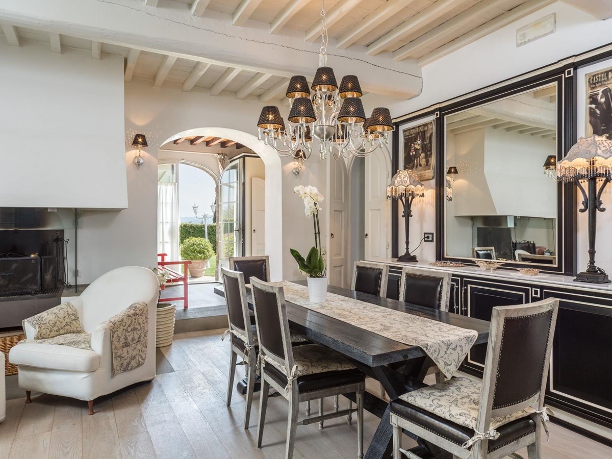 Indoor dining room in the kitchen with black furniture at Villa di Tignano in Tuscany