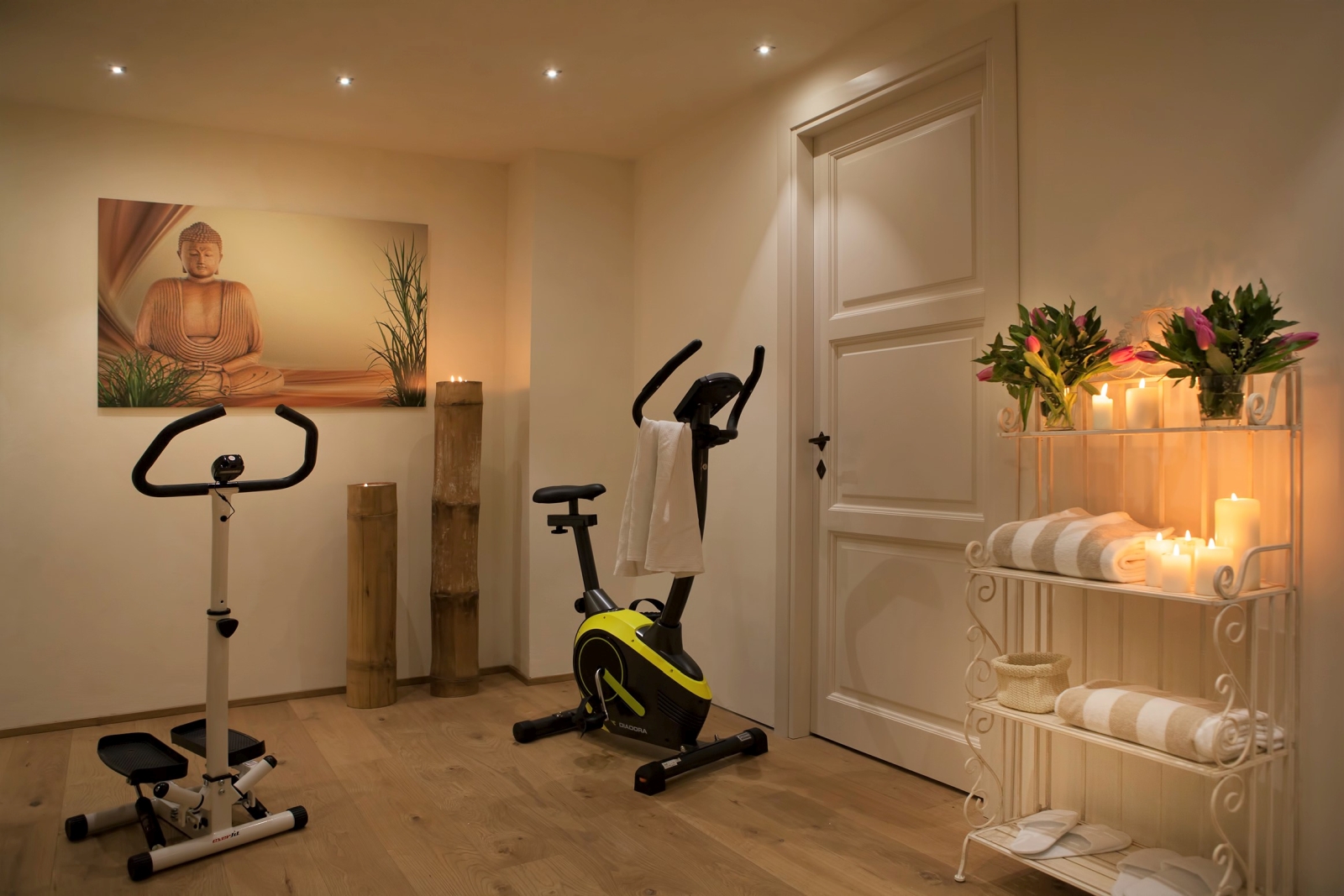 Gym with equipment, artwork, flowers, towels and candles at Villa di Tignano in Tuscany, Italy