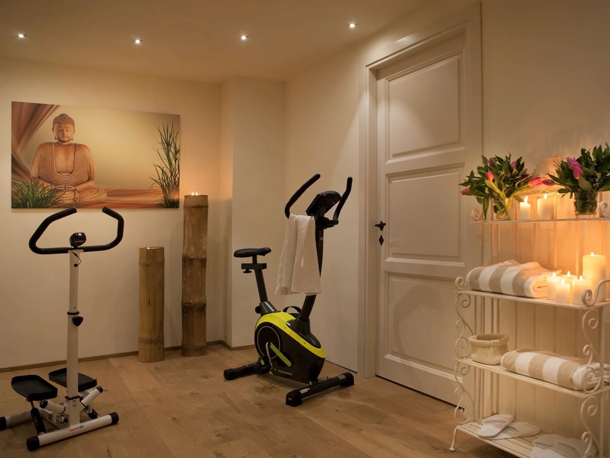 Gym with equipment, artwork, flowers, towels and candles at Villa di Tignano in Tuscany, Italy
