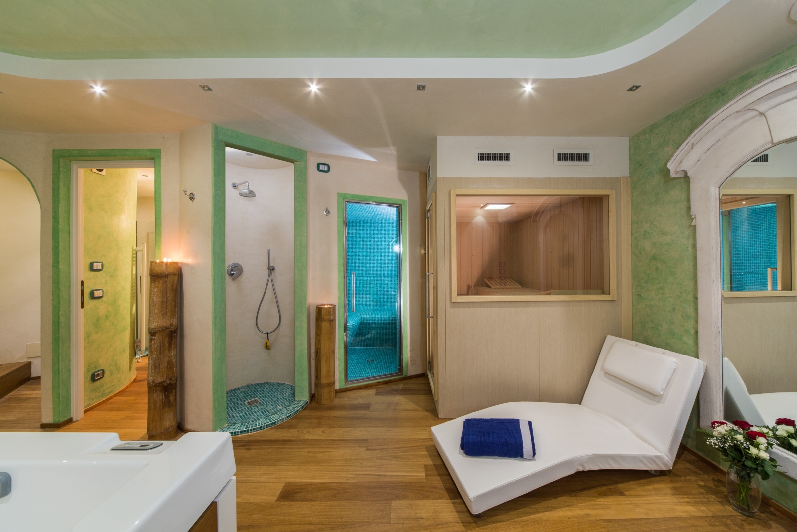 Spa room with jacuzzi, shower, lounge chair and sauna at Villa di Tignano in Tuscany, Italy