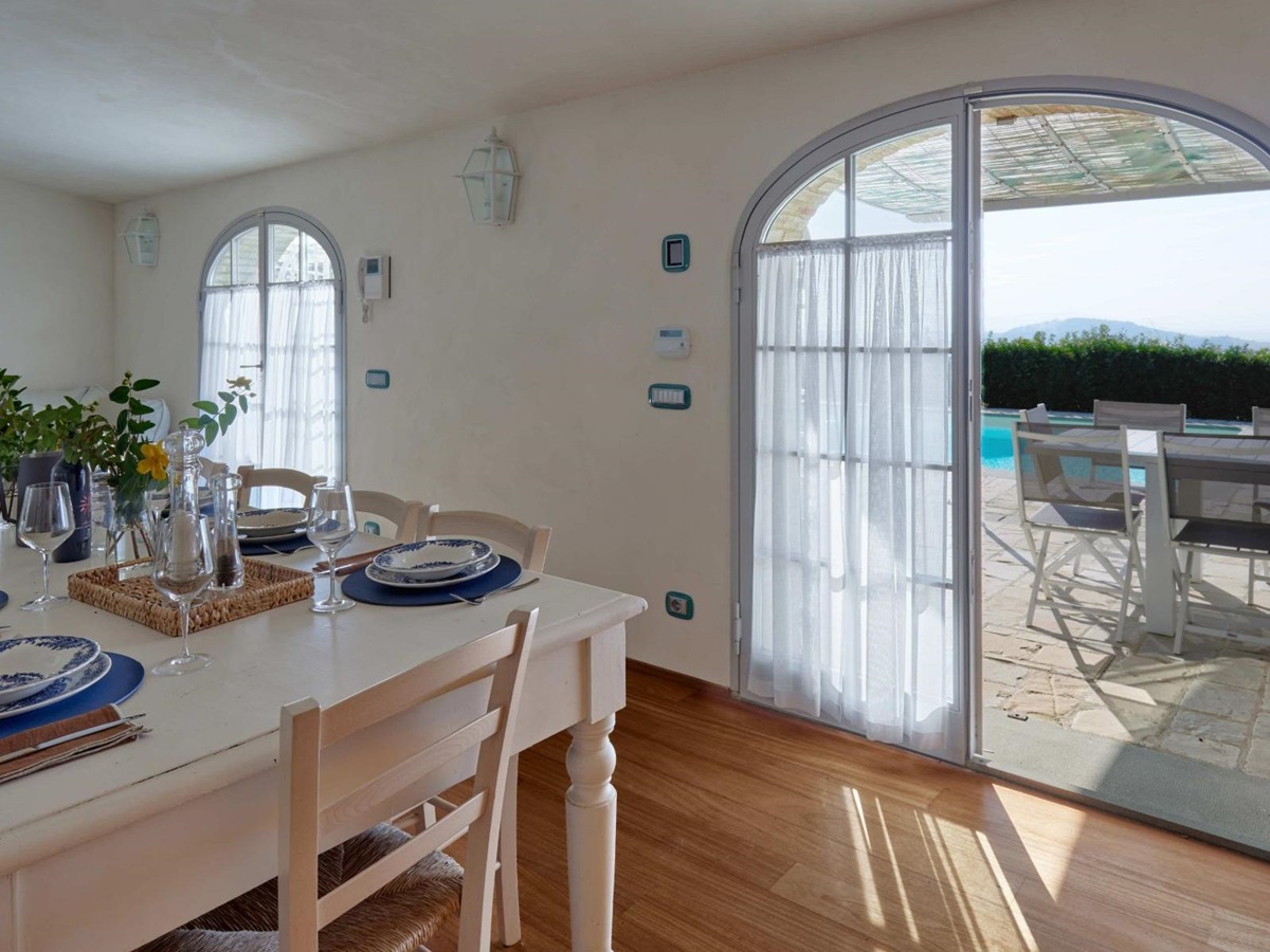 View of the outdoor pool area from inside the kitchen at Villa di Tignano in Tuscany