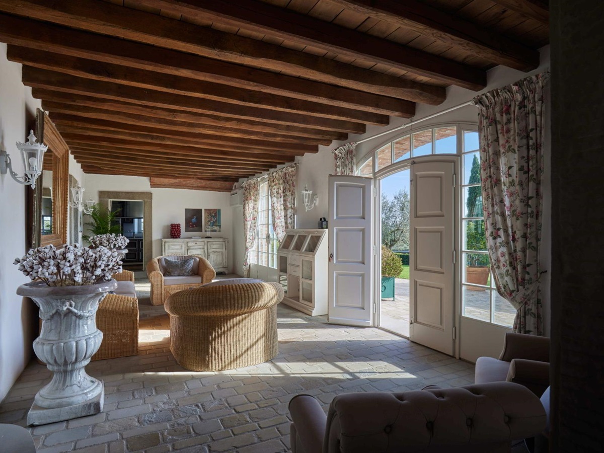 Living room with view of the outdoor area with large open doors at Villa di Tignano in Tuscany