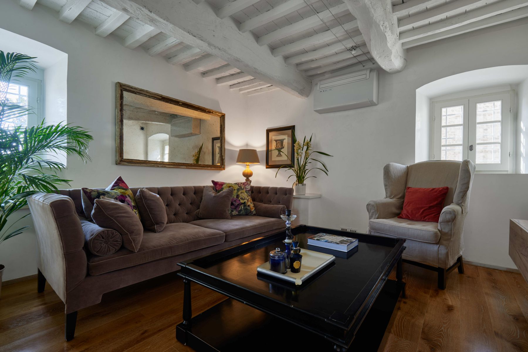 Small sitting room in the television room at Villa di Tignano in Tuscany with two sofas