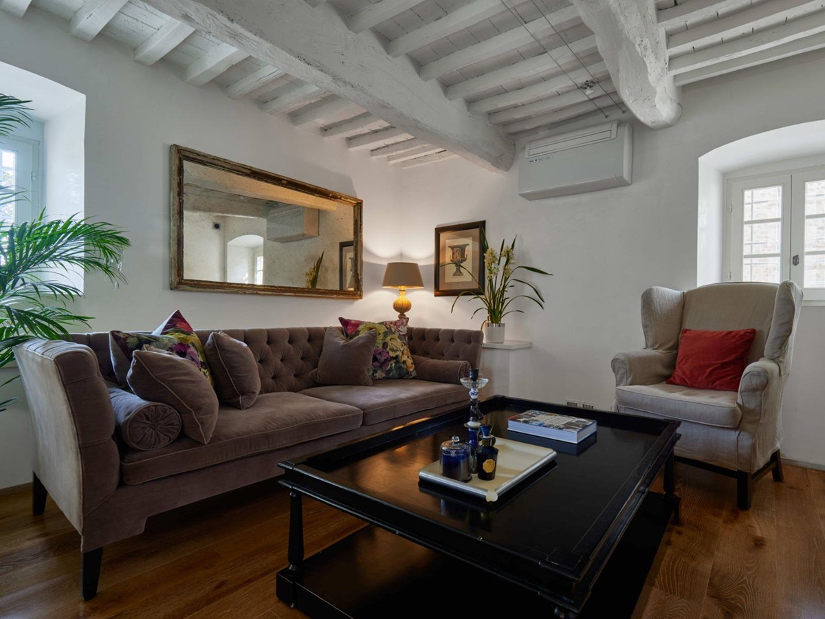 Small sitting room in the television room at Villa di Tignano in Tuscany with two sofas