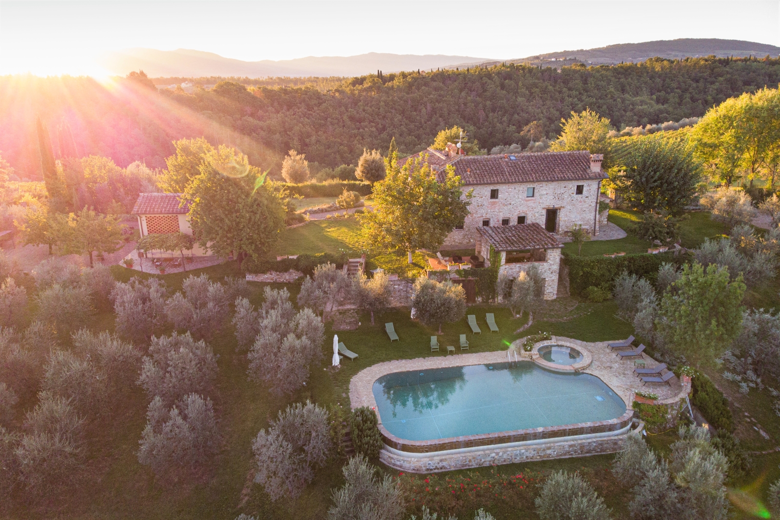 Aerial view of villa, gardens, guest house, pool and surrounding countryside at Villa Giuliana in Tuscany, Italy