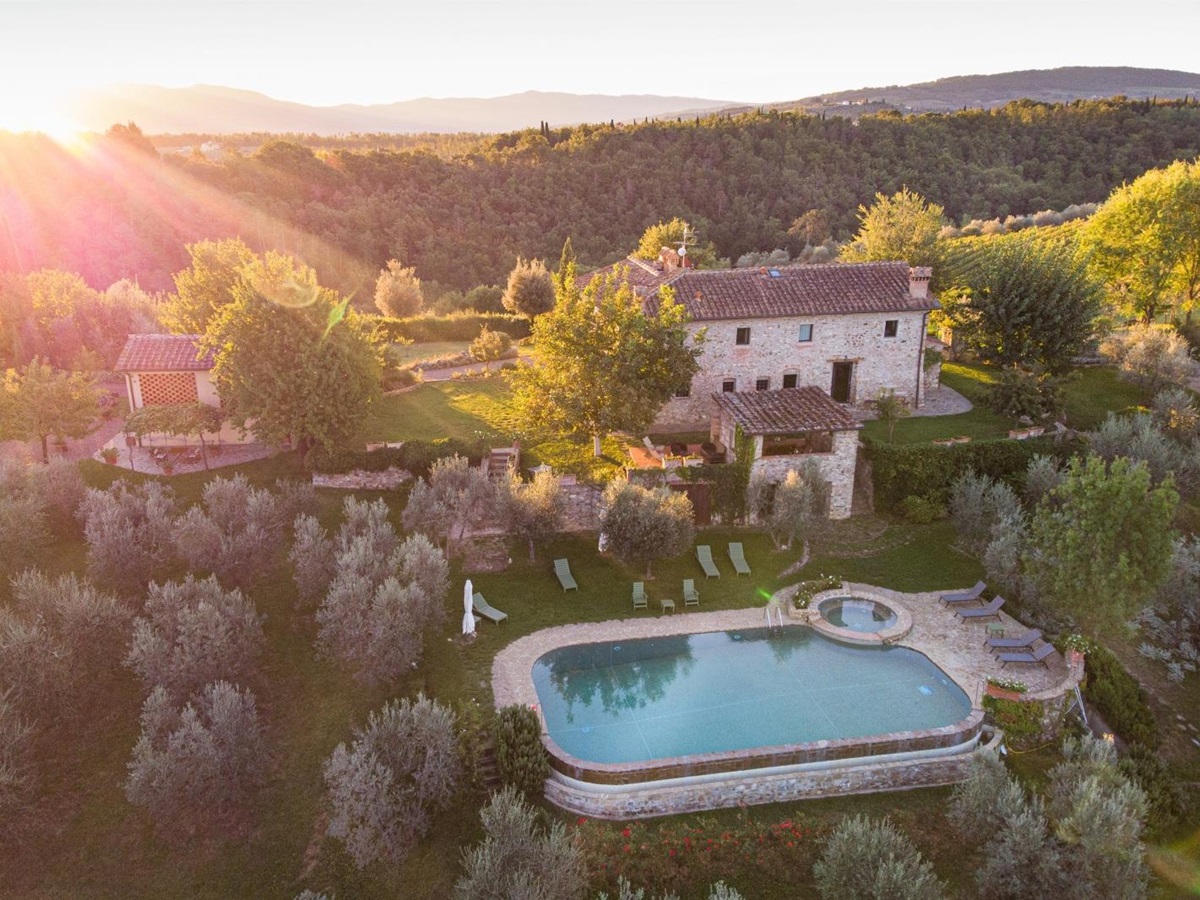 Aerial view of villa, gardens, guest house, pool and surrounding countryside at Villa Giuliana in Tuscany, Italy
