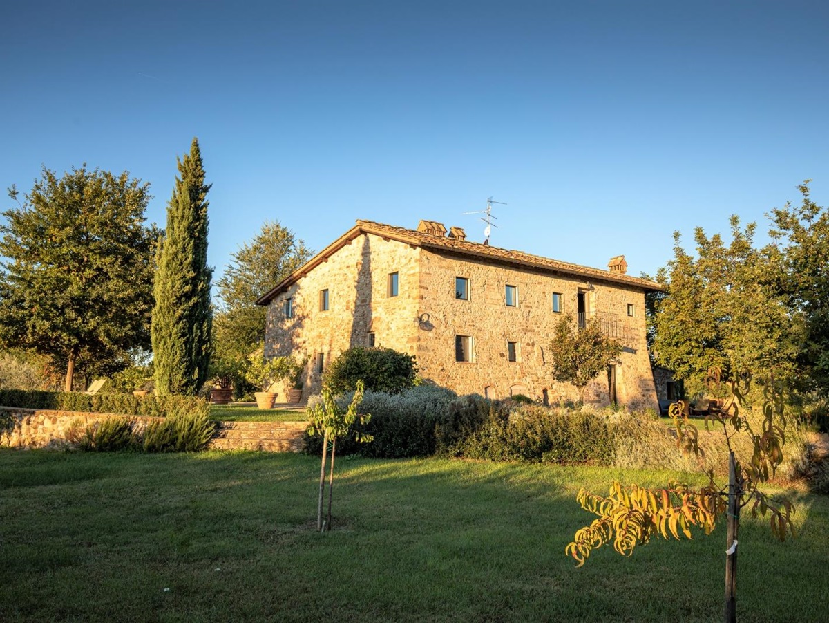 Exterior of villa and garden with trees and plants at Villa Giuliana in Tuscany, Italy