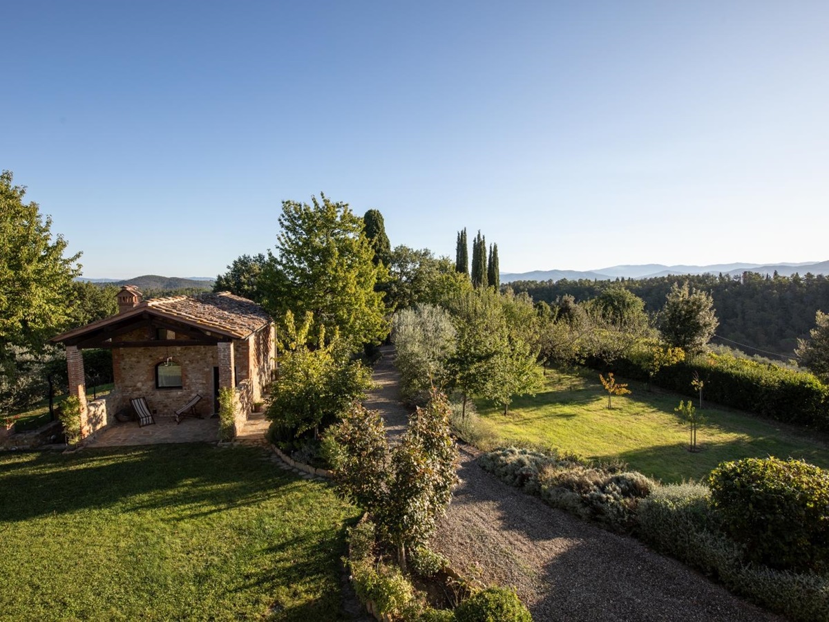 Annexe in garden with trees, plants and countryside view at Villa Giuliana in Tuscany, Italy