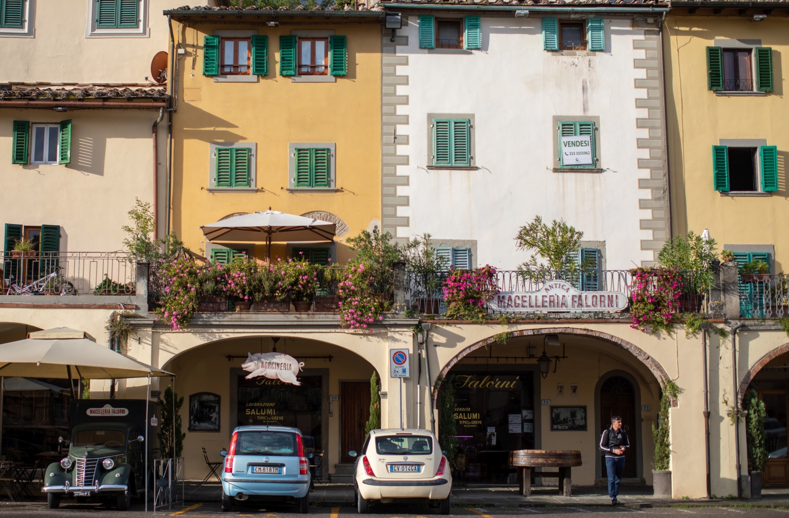 Lifestyle image of colourful houses, flowers and cars in Greve in Chianti near to Villa Giuliana in Tuscany, Italy