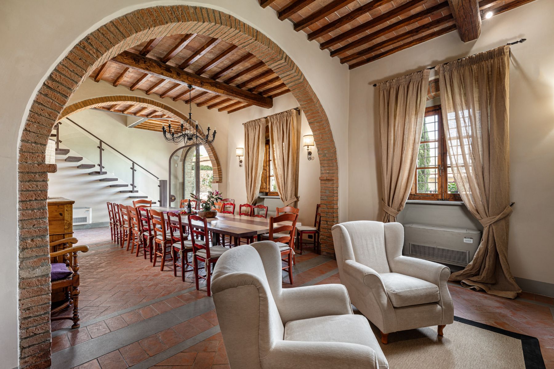 Indoor seating area with entrance into the dining area at Villa Il Sole in Tuscany