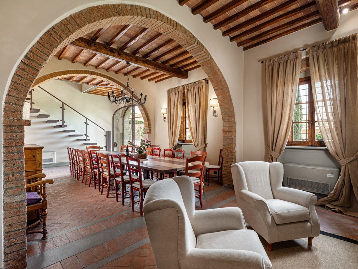 Indoor seating area with entrance into the dining area at Villa Il Sole in Tuscany