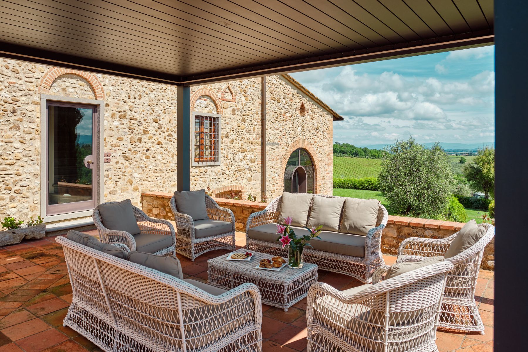 Outdoor lounge area in the courtyard overlooking the hills at Villa Il Sole in Tuscany