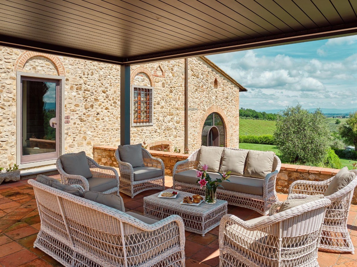 Outdoor lounge area in the courtyard overlooking the hills at Villa Il Sole in Tuscany