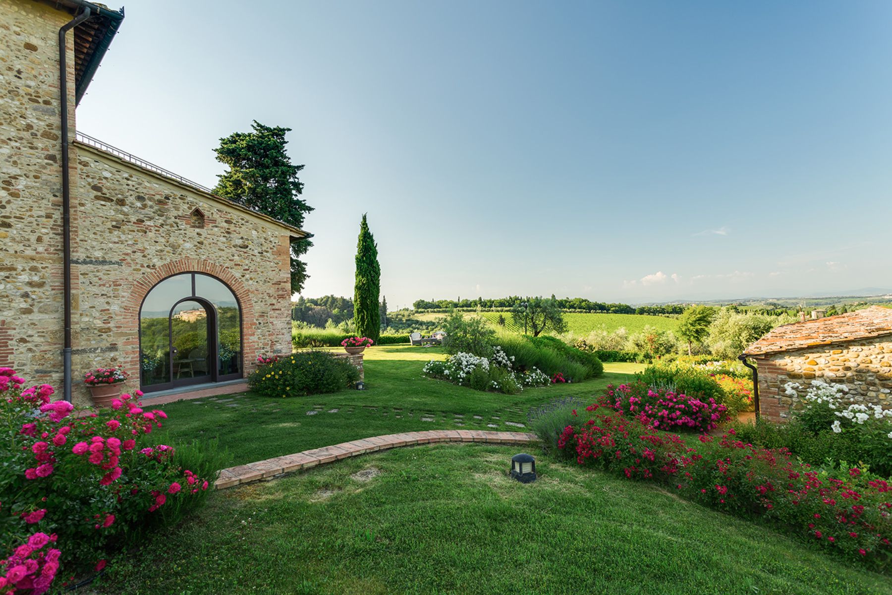 Gardens at Villa Il Sole in Tuscany, with view of the rolling hills