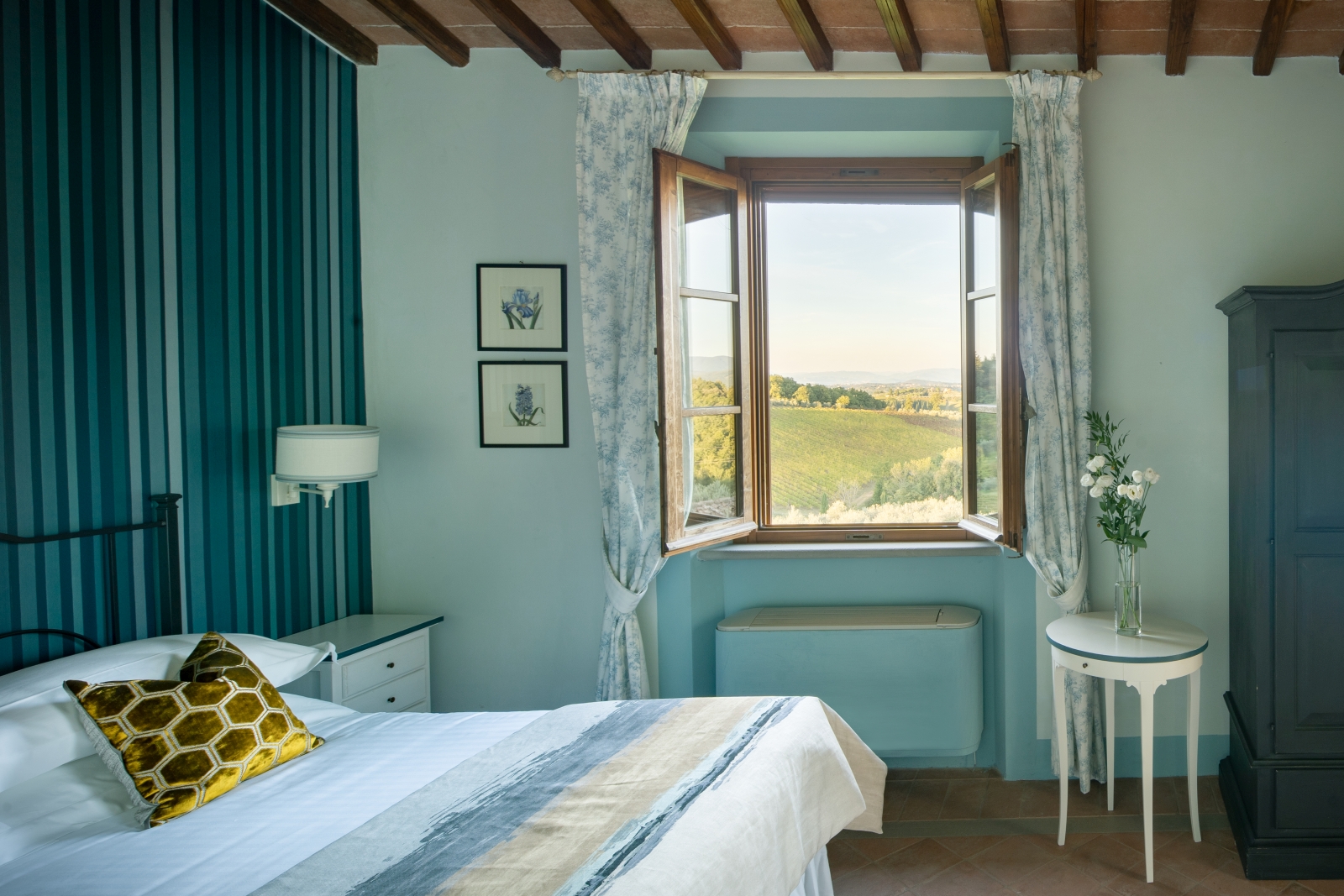 Double bedroom with blue furniture at Villa Il Sole in Tuscany