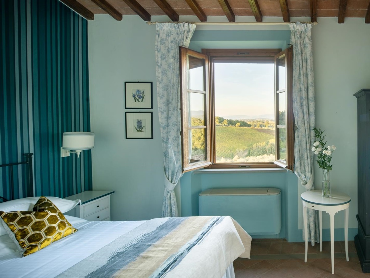 Double bedroom with blue furniture at Villa Il Sole in Tuscany