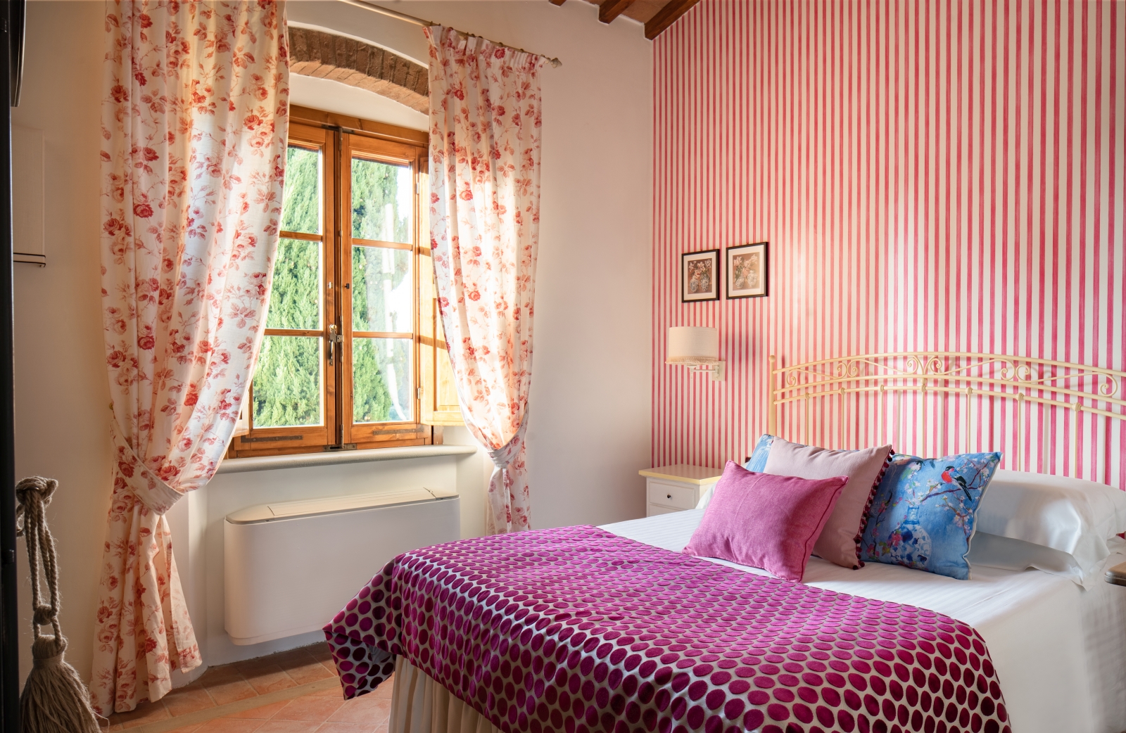Double bedroom with pink wallpaper at Villa Il Sole in Tuscany