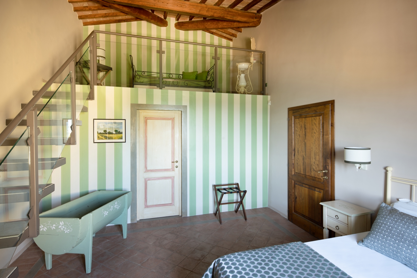 Double bedroom with striped wallpaper at Villa Il Sole in Tuscany