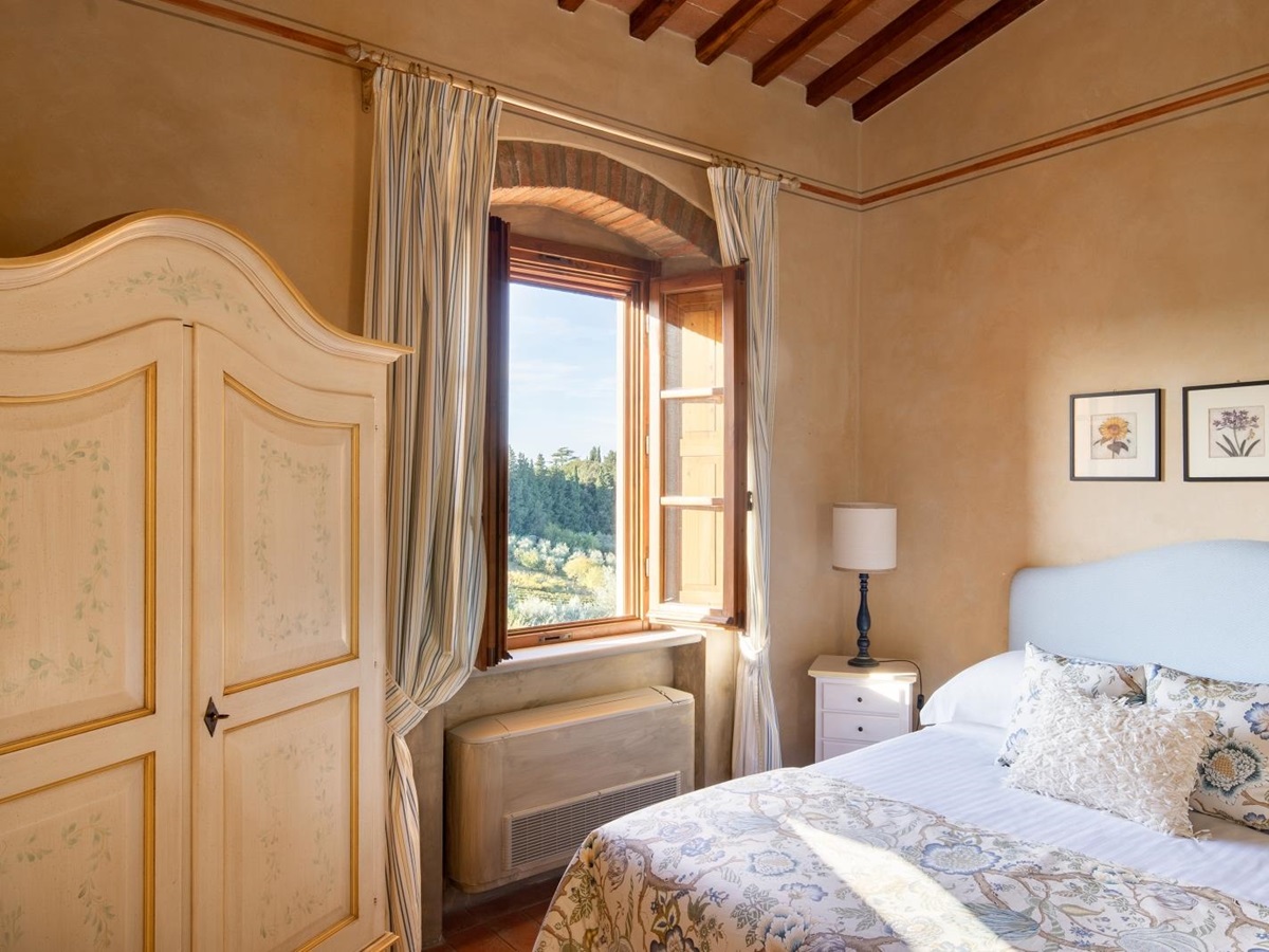 Double bedroom with large wardrobe at Villa Il Sole in Tuscany