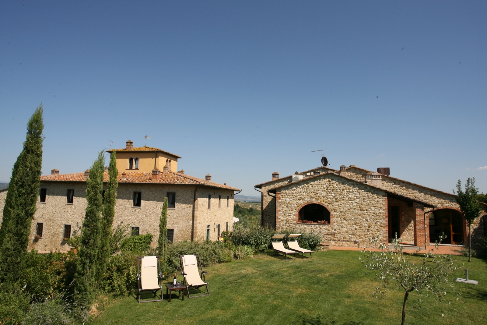 Exterior of property with garden in foreground at Villa Il Sole in Tuscany