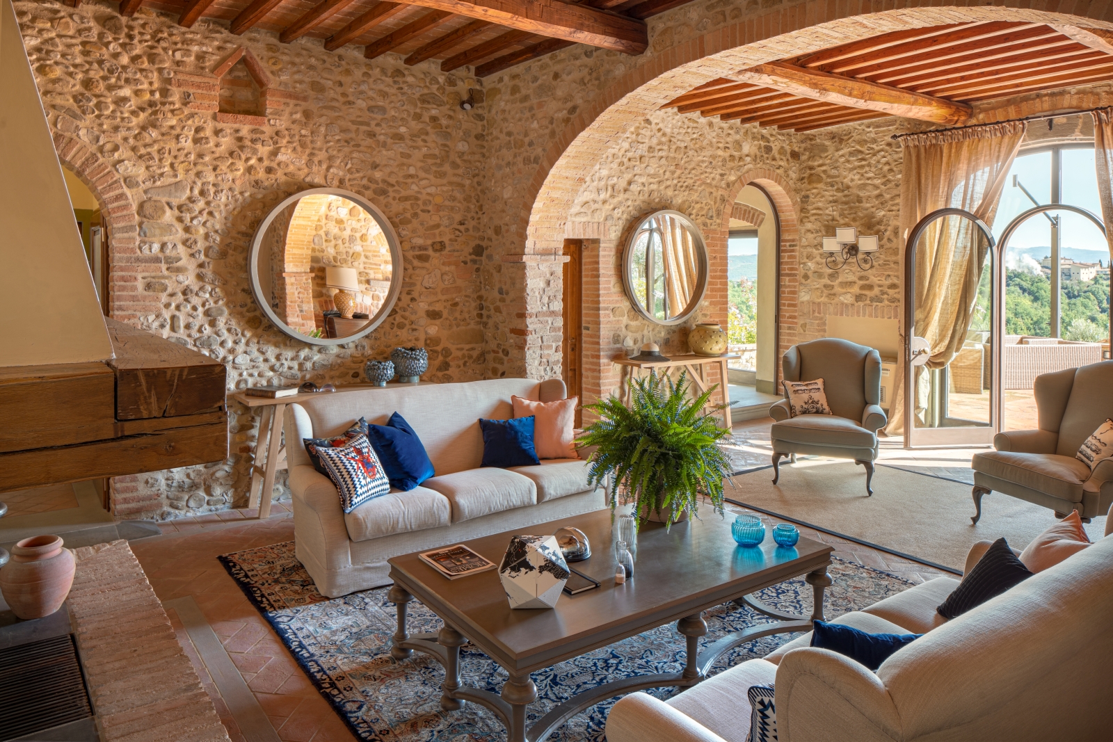 Living room with cream sofas at Villa Il Sole in Tuscany
