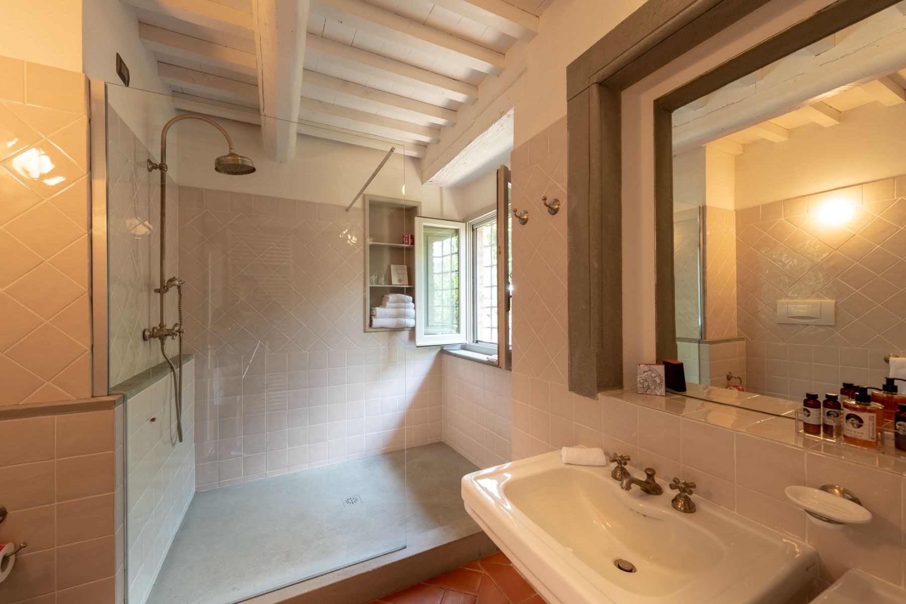 Bathroom at Villa Luce in Tuscany with pale pink tiles and a large shower
