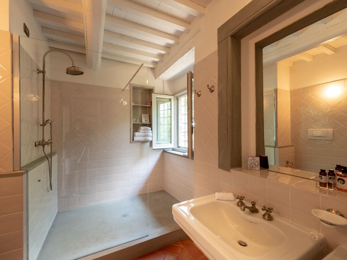 Bathroom at Villa Luce in Tuscany with pale pink tiles and a large shower