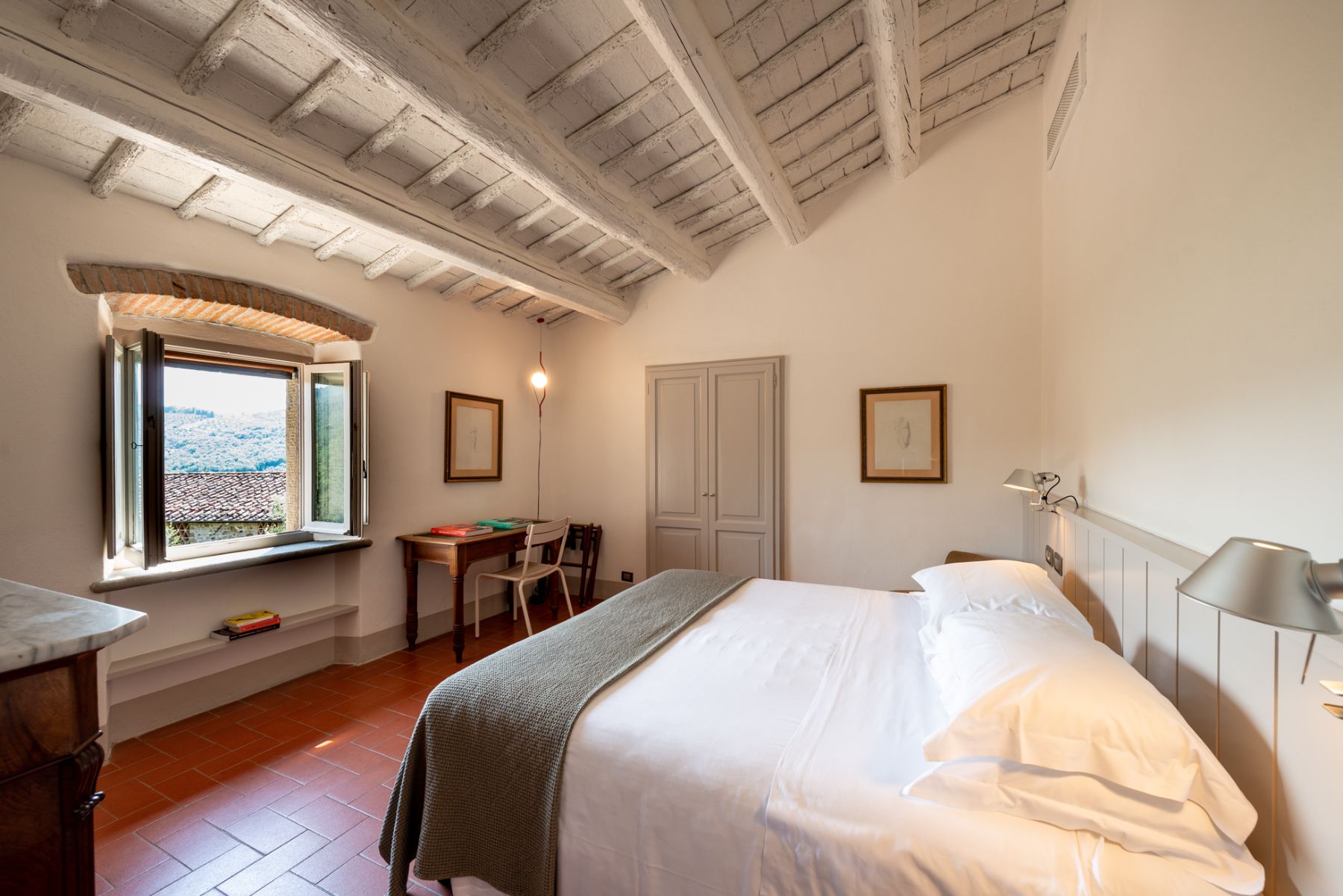 Double bedroom with wooden beam roof and modern decor at Villa Luce in Tuscany