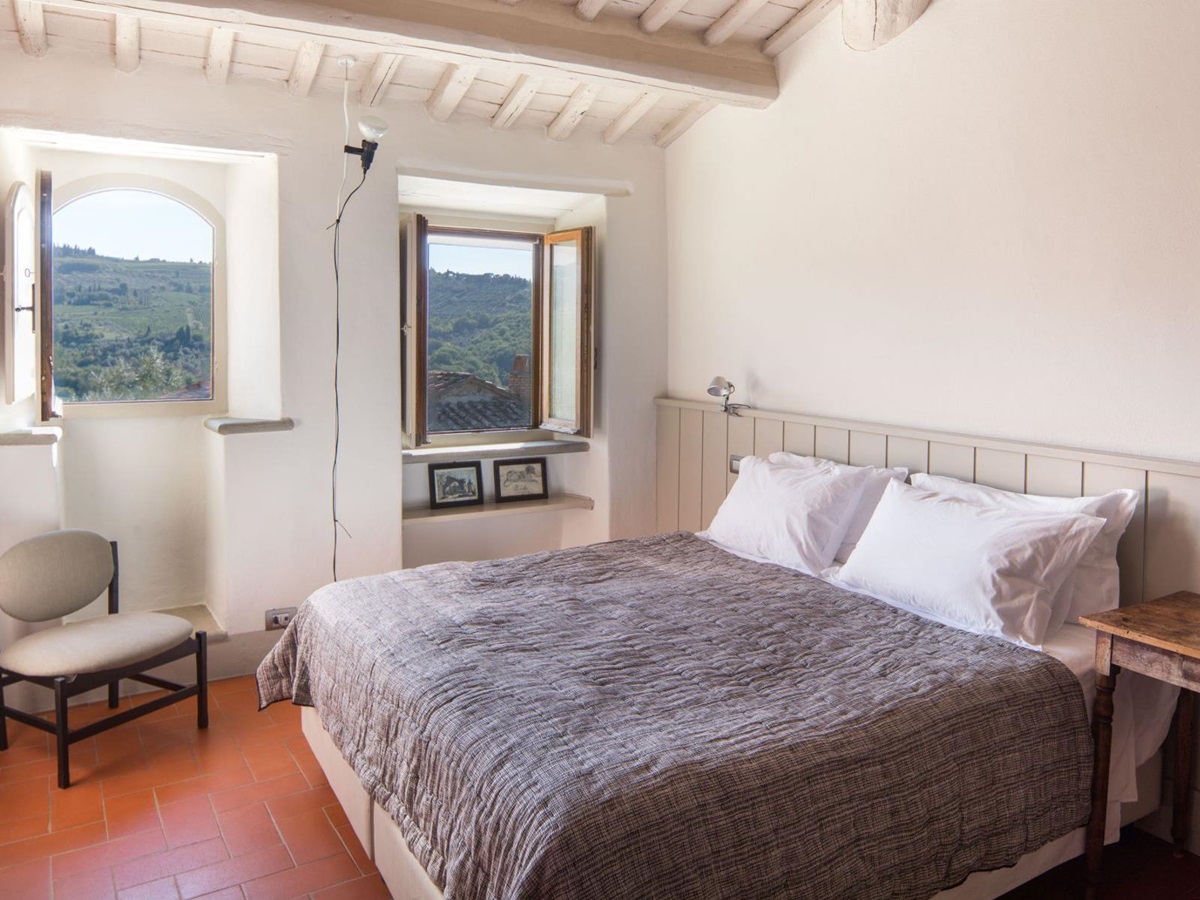 Bedroom with large double bed and modern decor at Villa Luce in Tuscany