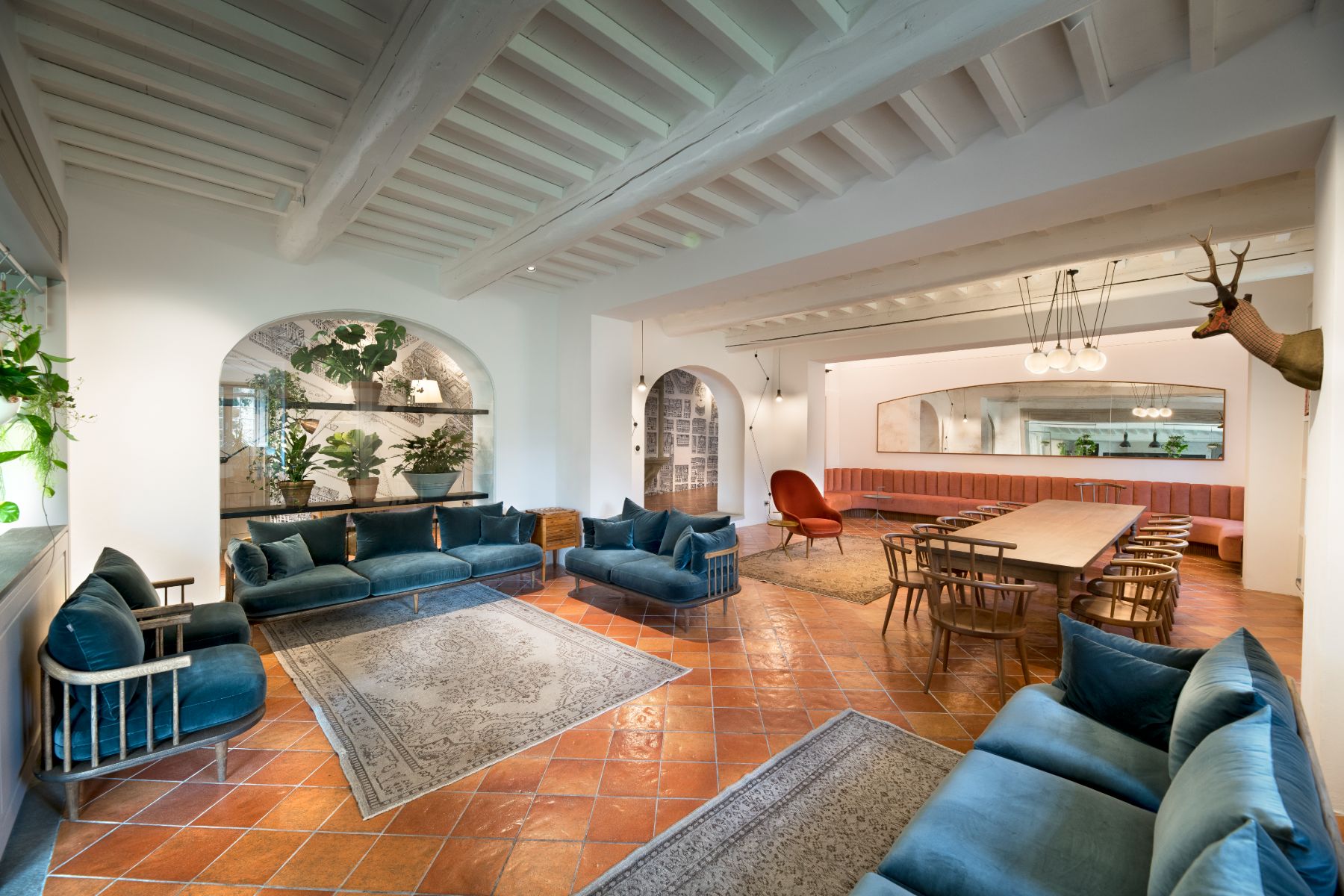 Large living room with blue sofas and dining table at Villa Luce in Tuscany