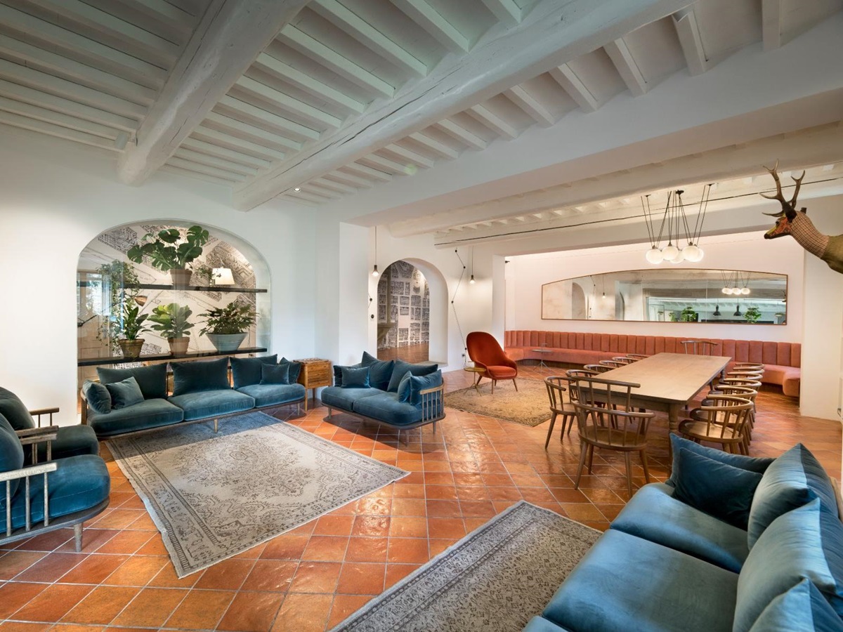 Large living room with blue sofas and dining table at Villa Luce in Tuscany