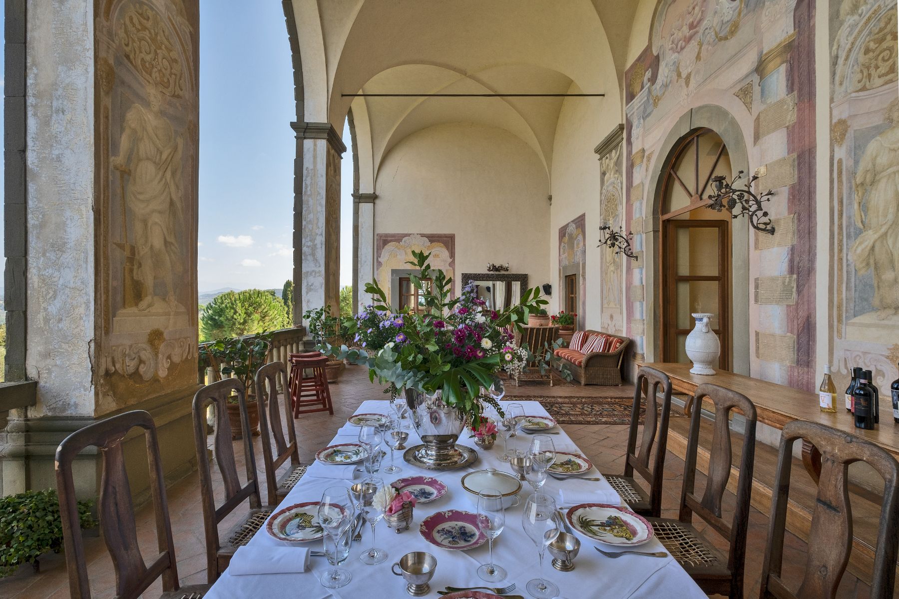 Outdoor dining table on the terrace at Villa Machiavelli in Tuscany