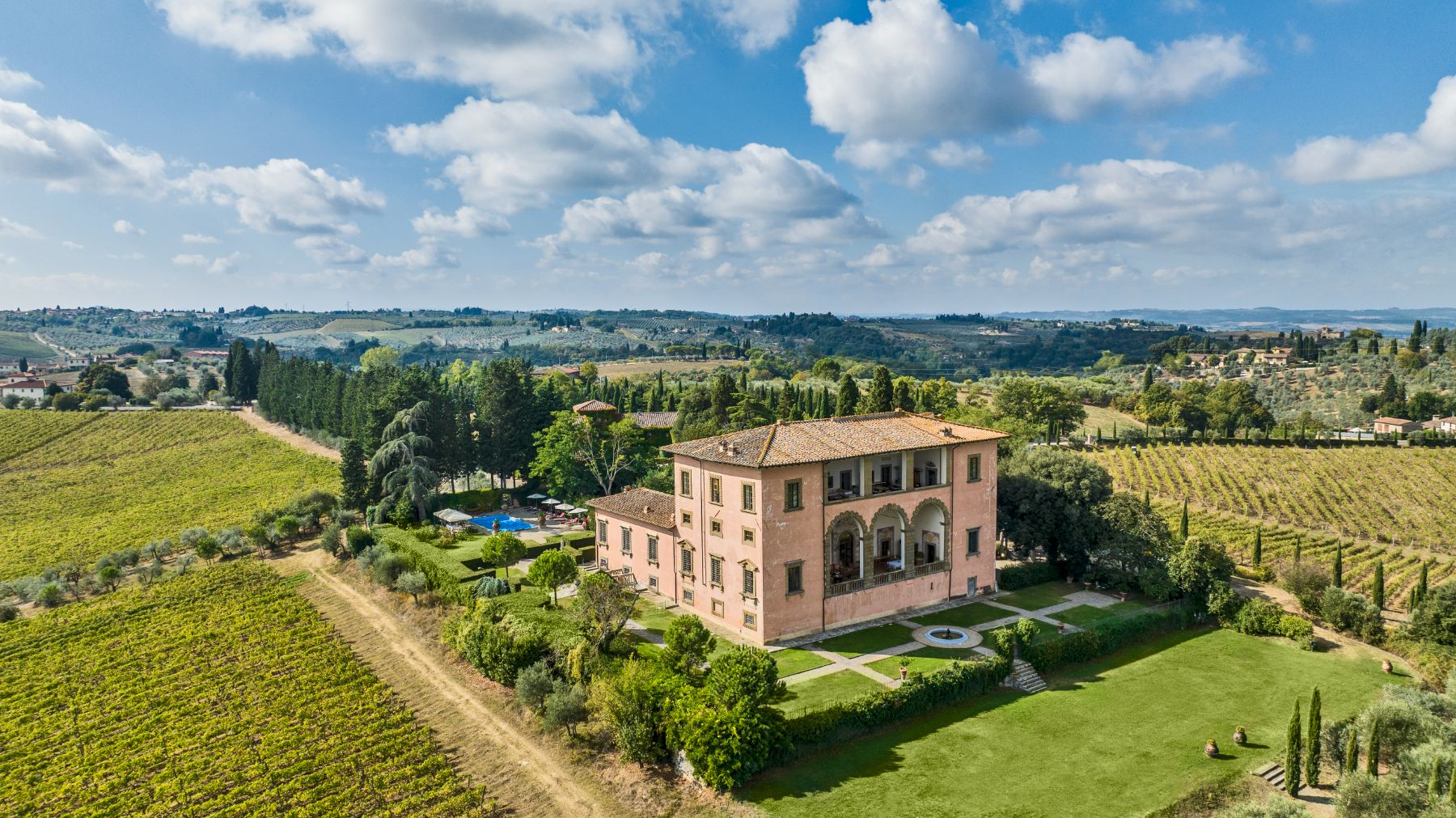 Drone view of the front of Villa Machiavelli in Tuscany with view of the gardens and the swimming pool at the back