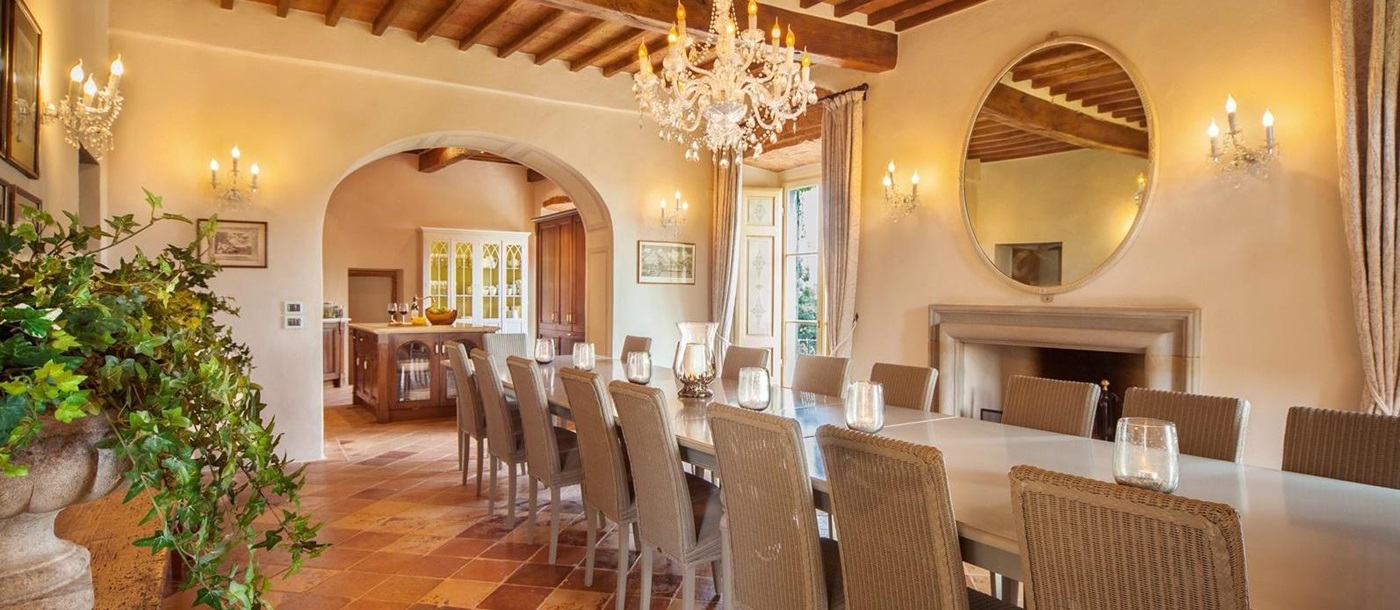 Well lit open dining room with chandelier in Villa Nocciola, Tuscany